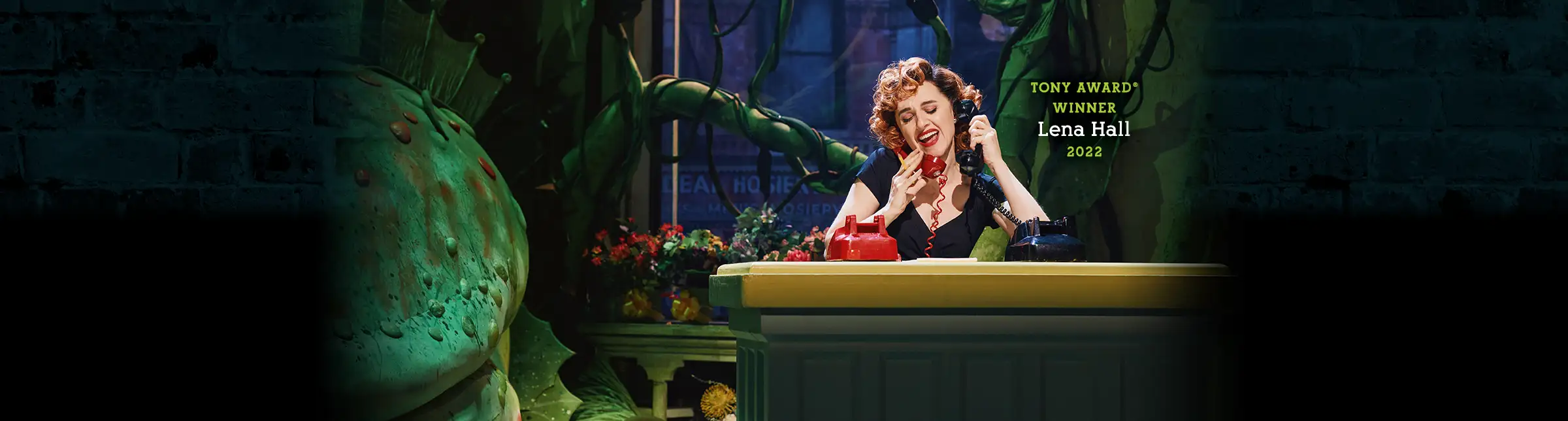 Tony Award winner Lena Hall in the 2022 Broadway cast of Little Shop of Horrors, performing beside the iconic Audrey II plant.