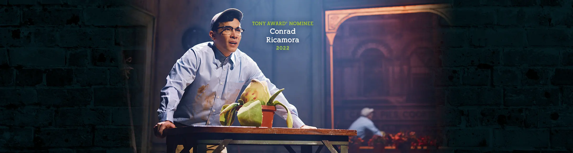 Tony Award nominee Conrad Ricamora in the 2022 Broadway cast of Little Shop of Horrors, performing alongside the Audrey II plant.