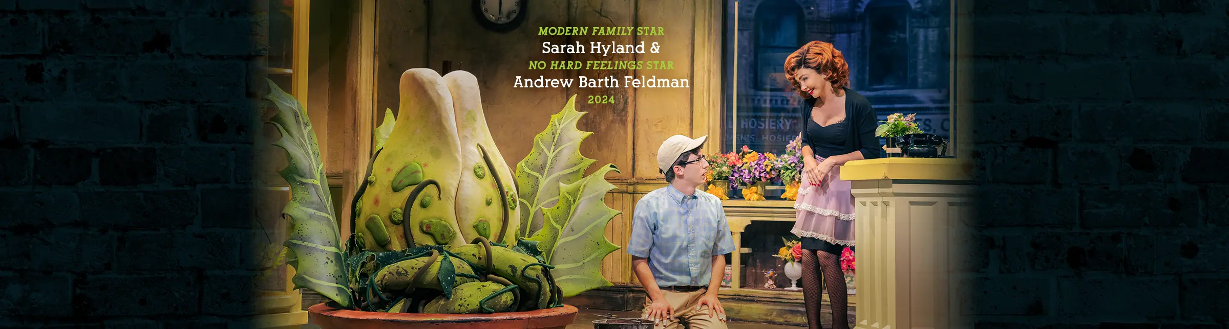 Sarah Hyland and Andrew Barth Feldman in the 2024 Broadway cast of Little Shop of Horrors, performing alongside the Audrey II plant.